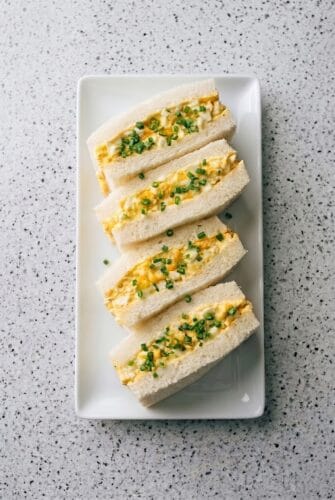 Japanese Egg Sandwich Recipe - Authentic Tamago Sando Japanese egg sandwiches arranged on a platter with creamy tamago filling and soft crustless bread.