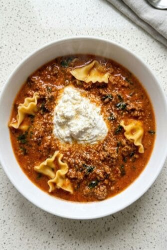 Lasagna soup with bowtie pasta, ground beef, and a creamy ricotta topping.