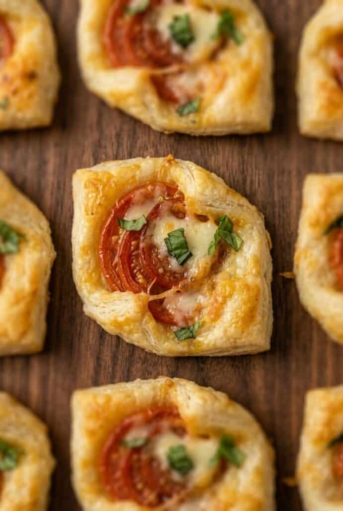 Close-up of flaky pepperoni tomato basil puff pastry bite, a crispy cheesy appetizer perfect for easy party recipes.