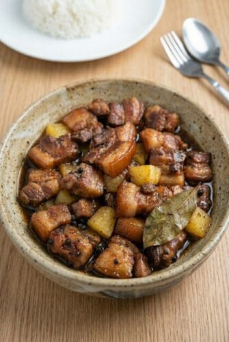 Simple Authentic Filipino Pork Hamonado Recipe Pork Hamonado with caramelized pork belly and pineapple chunks, showcasing the sweet and savory Filipino dish.