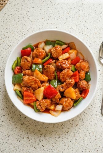 Sweet and Sour Pork Recipe | Simple Restaurant-Style Dinner at Home Bowl of homemade sweet and sour pork with crispy pork pieces, pineapple, and colorful vegetables.