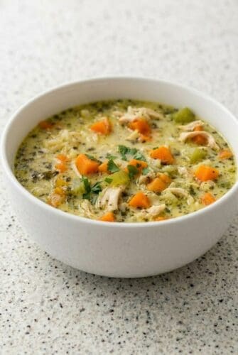 Turkey and Rice Soup Recipe - Simple Ingredients, Maximum Flavor Bowl of creamy turkey and rice soup with carrots and herbs, a cozy leftover turkey soup recipe.