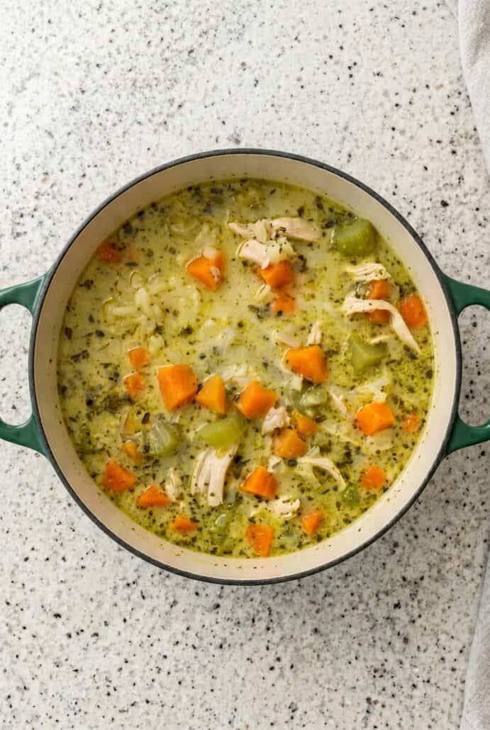 Pot of creamy turkey and rice soup with carrots and herbs, an easy one-pot leftover turkey soup recipe.