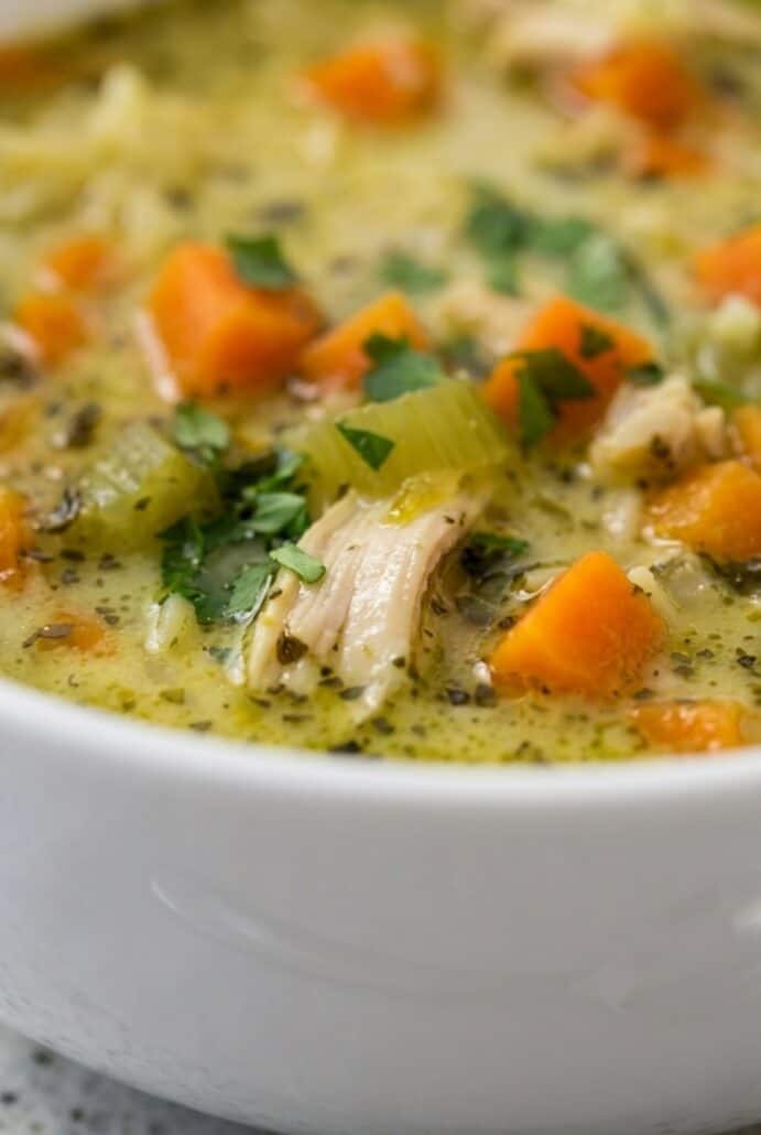 Close-up of creamy turkey and rice soup with tender turkey, carrots, and herbs, a cozy leftover turkey soup recipe.