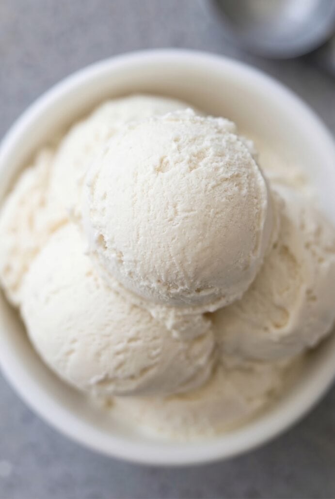 Close-up of a scoop of creamy homemade vanilla ice cream, highlighting the smooth texture.