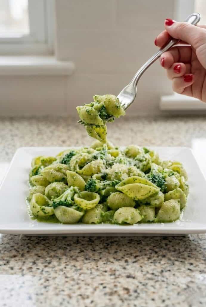 Fork lifting broccoli shell pasta with garlic and Parmesan, highlighting a quick healthy pasta recipe ready to serve.