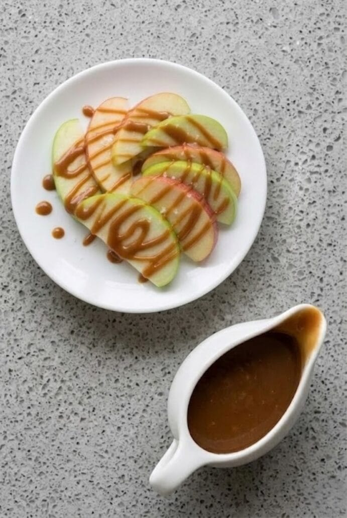 Caramel sauce with sliced apples for an easy homemade fruit dessert.