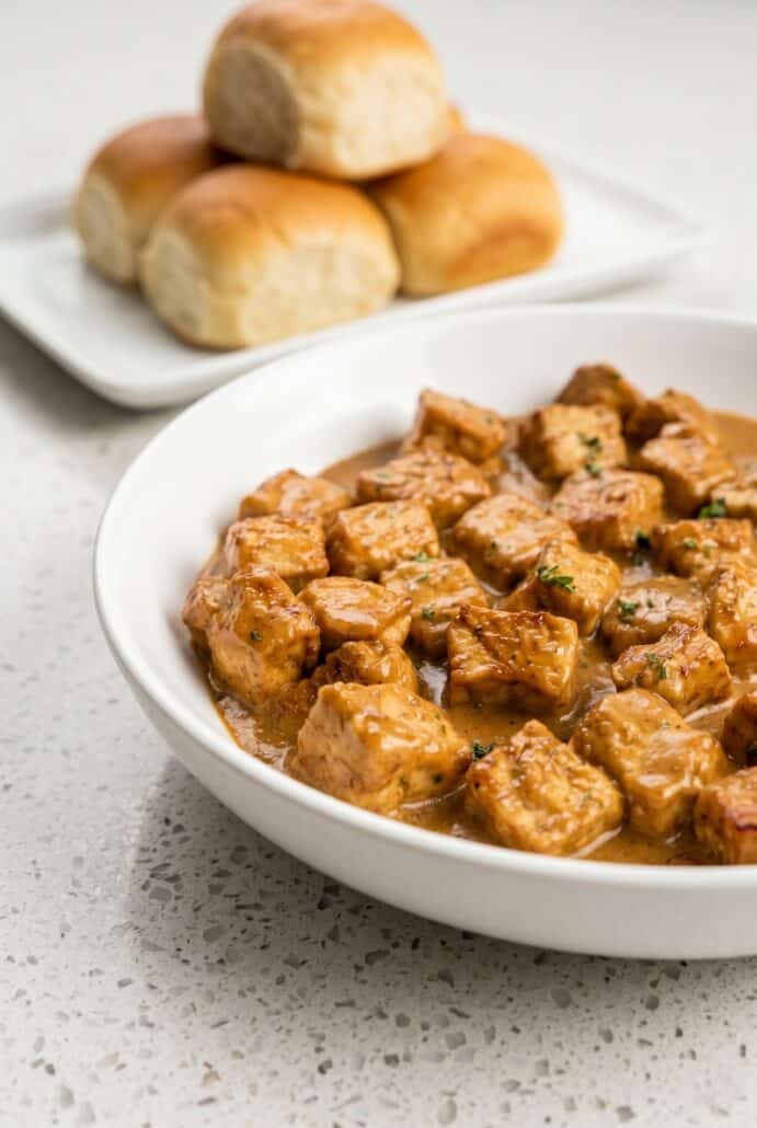 Creamy garlic pork bites served in a white bowl for an easy dinner recipe.