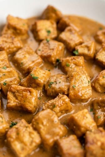 Garlic Pork Bites Recipe (Tender, Juicy & Full Of Flavor!) Close-up of creamy garlic pork bites with parsley for a rich and easy skillet pork dinner.
