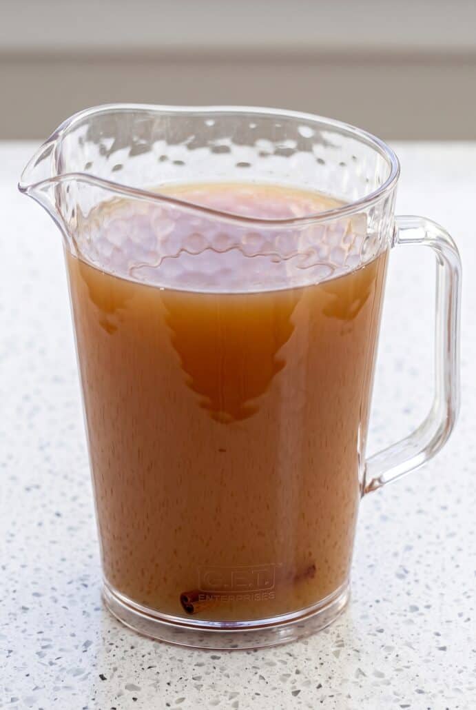 Strained homemade apple cider in a pitcher, ready to serve hot or cold.