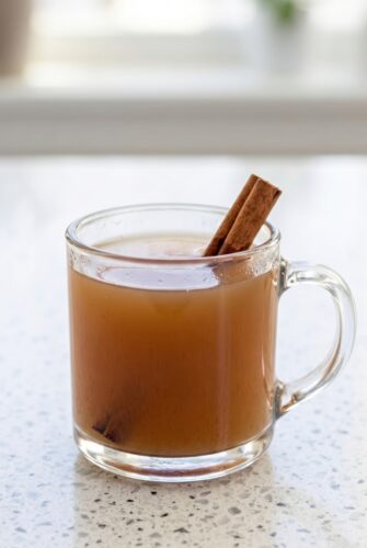 Homemade Apple Cider Recipe (Warm, Spiced & So Cozy!) Hot homemade apple cider in a glass mug with cinnamon stick garnish.