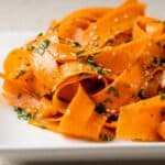 Raw carrot salad with thin carrot ribbons, herbs, and sesame seeds.
