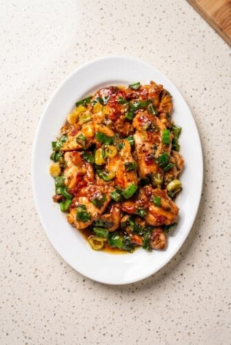 Juicy Scallion Chicken Thighs Recipe - Ready in 20 Minutes! Scallion chicken made with juicy pan-fried chicken thighs, savory sauce, and fresh green onions.