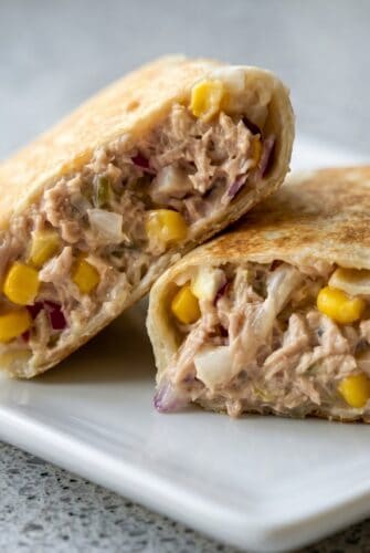 Crispy Tuna Melt Wrap Recipe – Better Than a Sandwich! Crispy tuna melt wrap cut in half with creamy tuna, corn, and melted cheese filling.