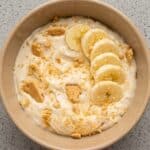 Creamy Banana Pudding Yogurt bowl topped with fresh banana slices and graham cracker crumbs.