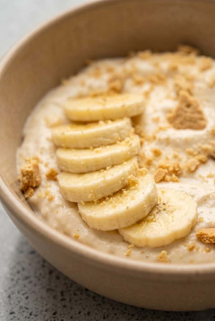 Close-up of Banana Pudding Yogurt topped with banana slices and graham cracker crumbs.
