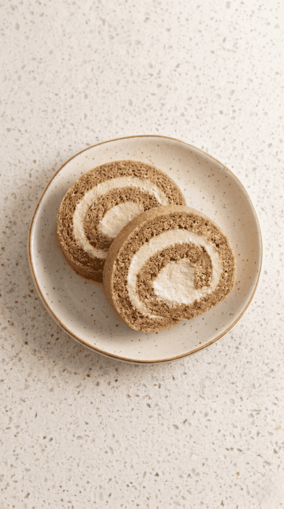 Coffee Swiss Roll slices with a soft espresso cream swirl on a plate.