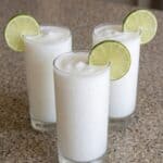 Creamy Colombian coconut limeade served cold with fresh lime garnish.