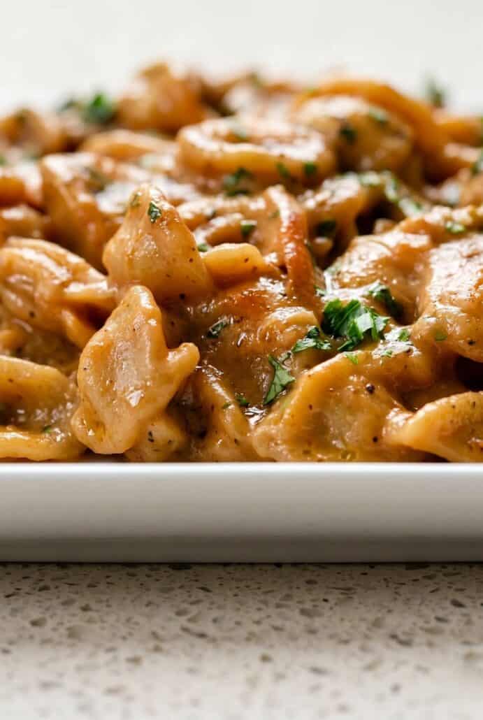 Close-up of creamy French Onion Pasta with tender orecchiette, caramelized onions, melted cheese, and parsley.
