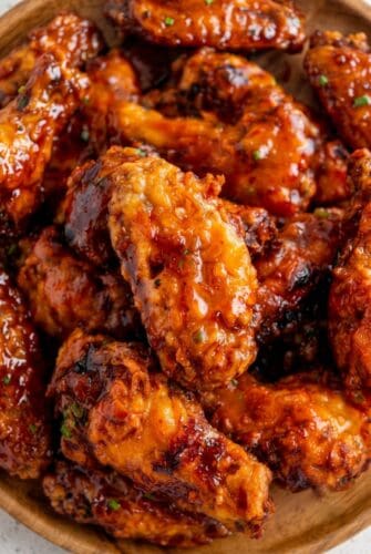 Hot Honey Peach Wings Recipe - Sweet, Spicy & Better Than Takeout! Hot Honey Peach Wings coated in a sticky sweet and spicy peach glaze.