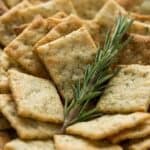Homemade rosemary sea salt crackers served with fresh rosemary for an easy snack or appetizer.