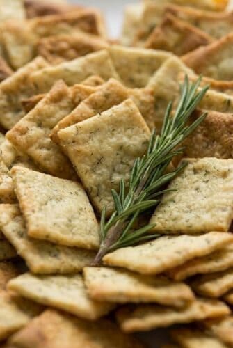 Crispy Homemade Rosemary Sea Salt Crackers Recipe Homemade rosemary sea salt crackers served with fresh rosemary for an easy snack or appetizer.