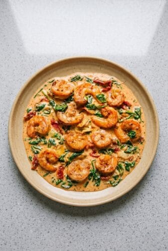 Tuscan Shrimp Recipe (Creamy, Garlicky & Ready in 15 Minutes!) Creamy Tuscan shrimp with spinach, sun-dried tomatoes, and artichokes in a skillet sauce.