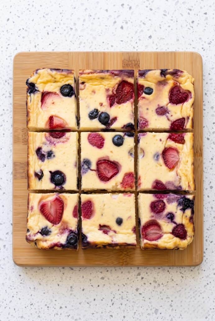 Baked yogurt squares topped with fresh strawberries, blueberries, and raspberries.