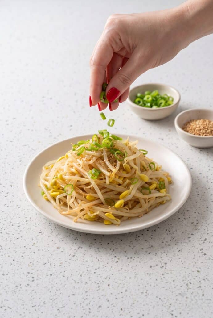 Green onions sprinkled over Korean bean sprout salad for fresh flavor.