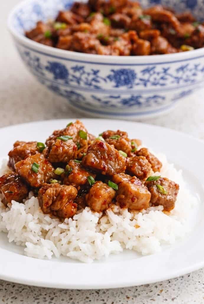 Garlic pork stir-fry served over fluffy white rice for a quick and flavorful dinner.