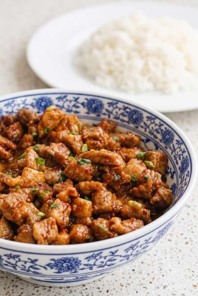 Garlic pork stir-fry served in a bowl with fluffy white rice for an easy dinner.