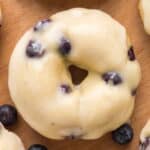 Glazed lemon blueberry donut topped with juicy blueberries.