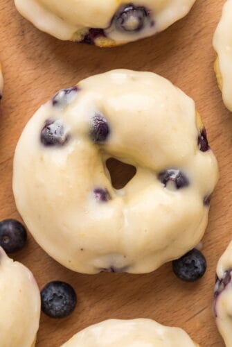 Fluffy Homemade Baked Lemon Blueberry Donuts Recipe Glazed lemon blueberry donut topped with juicy blueberries.