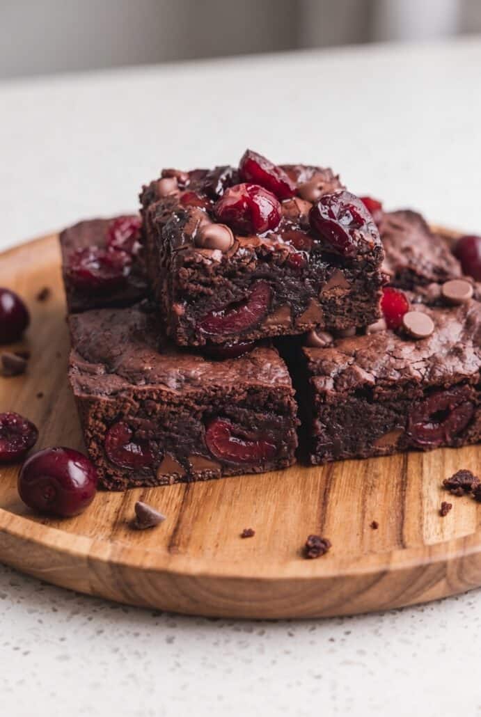 Stacked roasted cherry brownies with gooey centers, fresh cherries, and chocolate chips.