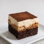 Tiramisu brownie with fudgy chocolate base, espresso-soaked layer, mascarpone cream, and cocoa topping.