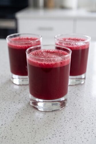 Watermelon Cherry Berry Beet Juice Recipe (Antioxidant Packed!) Three glasses of vibrant red homemade fruit juice ready to serve.