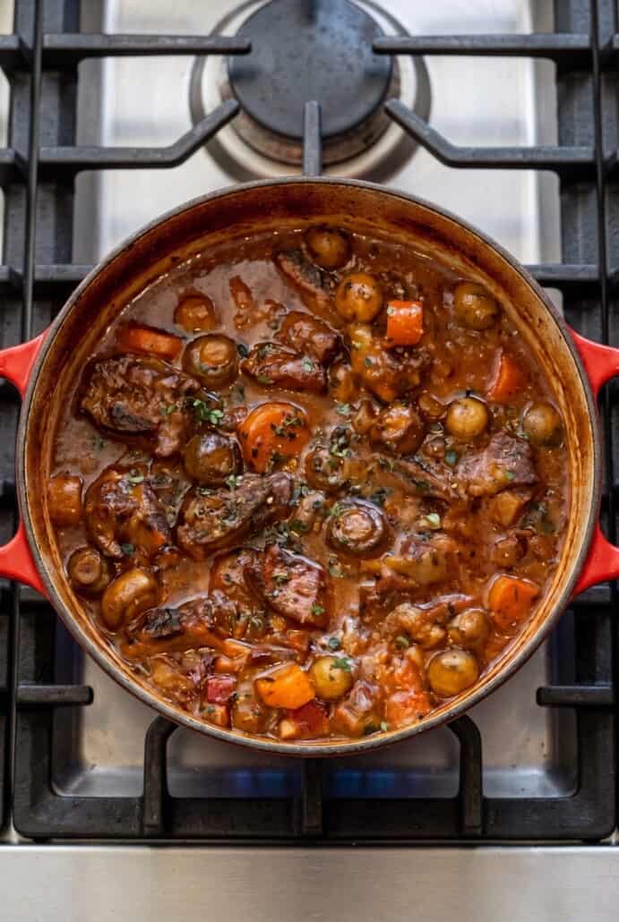 Overhead view of Beef Carbonnade Stew with tender beef, carrots, mushrooms, and onions simmered in a rich beer sauce.
