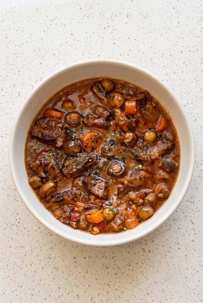 Beef Carbonnade Stew with tender beef, carrots, mushrooms, and onions in a rich beer sauce.