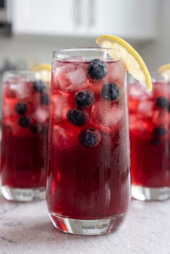 Refreshing Blueberry Lemonade Recipe Blueberry lemonade with fresh blueberries, lemon slices, and ice in glasses.