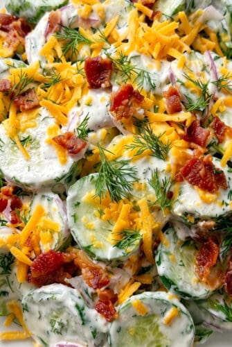 Creamy Cucumber Ranch Crack Salad Recipe Creamy cucumber ranch crack salad topped with cheddar, bacon, and fresh dill.