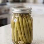 Jar of homemade dill pickled green beans ready for serving or pantry storage.
