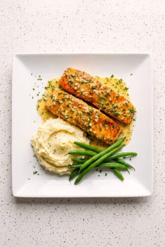 Simple Garlic Butter Salmon Dinner Recipe Golden garlic butter salmon fillets garnished with fresh herbs.