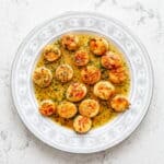 Golden garlic butter scallops topped with parsley and served in a flavorful lemon garlic butter sauce.