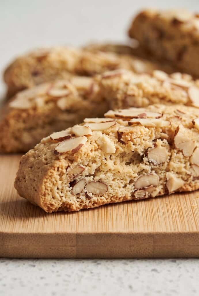 Close-up of almond biscotti showing the crunchy almond-filled center and sliced almond topping.