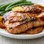 Bourbon peach roasted salmon with glazed salmon fillets, fresh peaches, and green beans.