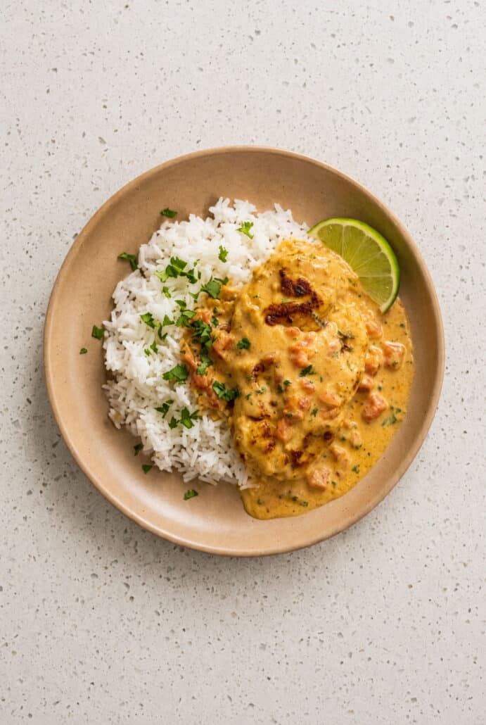 Creamy Cajun chicken served with lime in a rich skillet sauce.