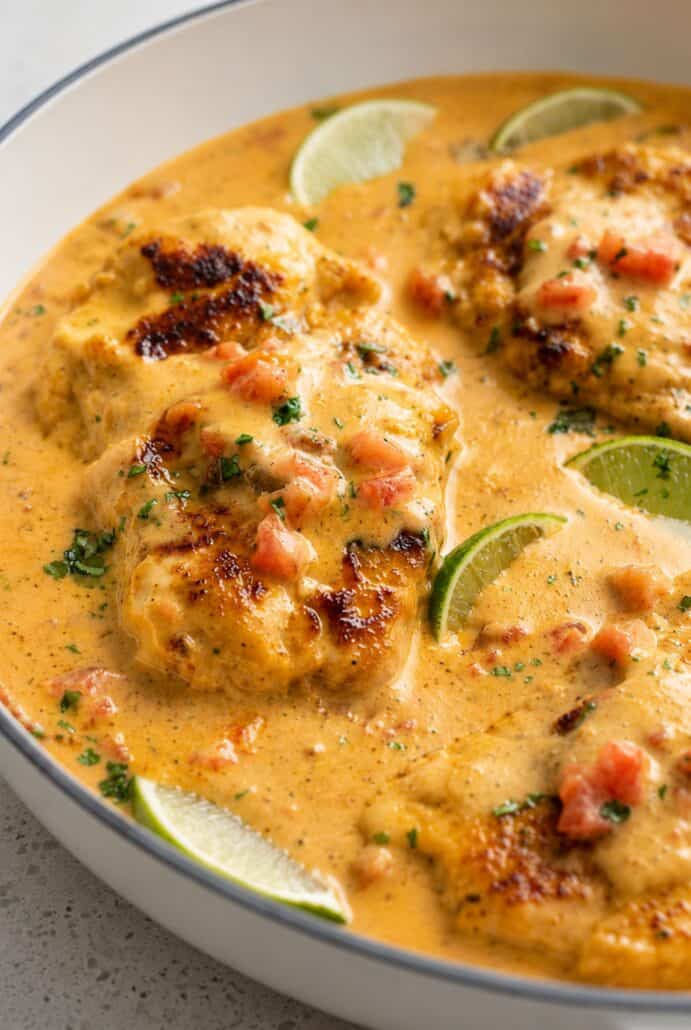Creamy Cajun chicken in a spicy skillet sauce with lime slices.