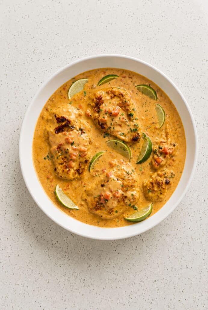 Creamy Cajun chicken served with lime in a rich skillet sauce.