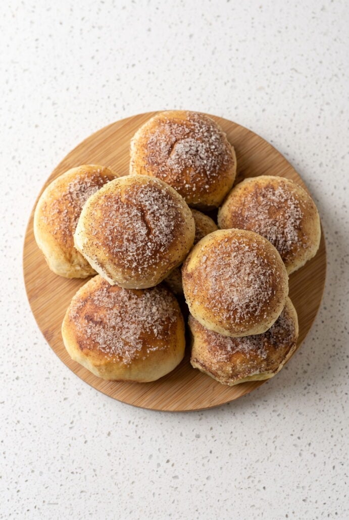 Golden caramel apple pie bombs sprinkled with cinnamon sugar and ready to serve.