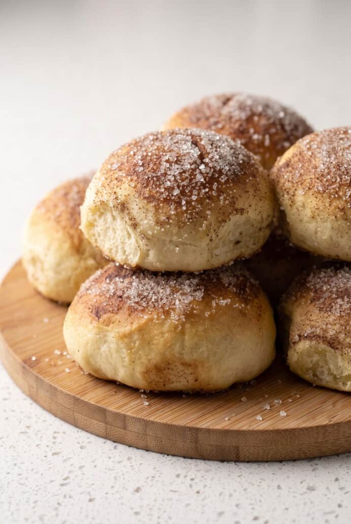 Freshly baked caramel apple pie bombs with a golden cinnamon sugar topping.
